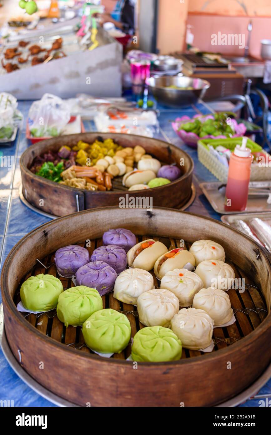 Traditional steamed Thai dumplings on sale in bamboo steamers at a street food market stall, Kata, Phuket, Thailand Stock Photo