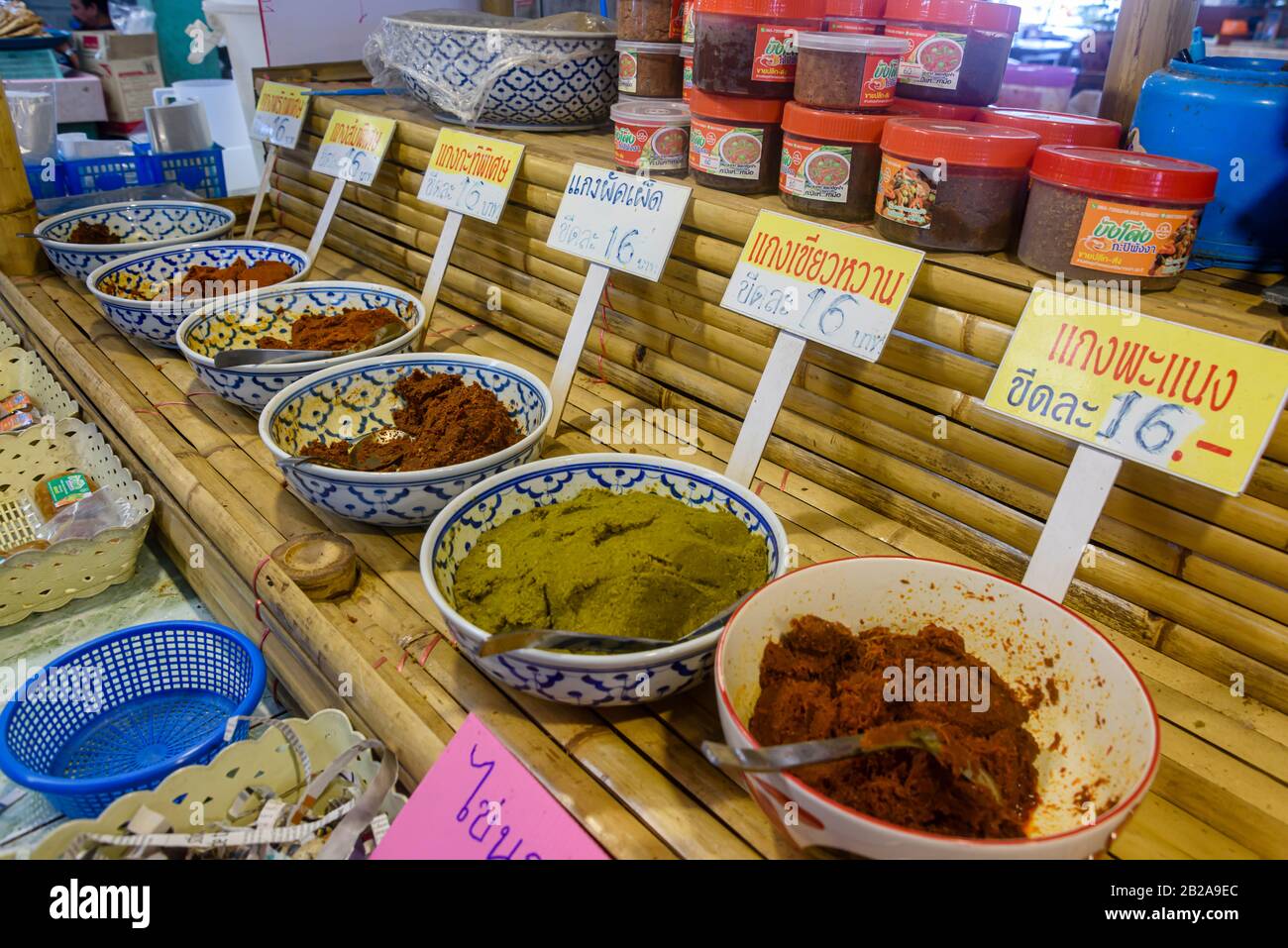 Bowls of homemade chili and spice paste for sale at a Thai food market stall, Thailand Stock Photo