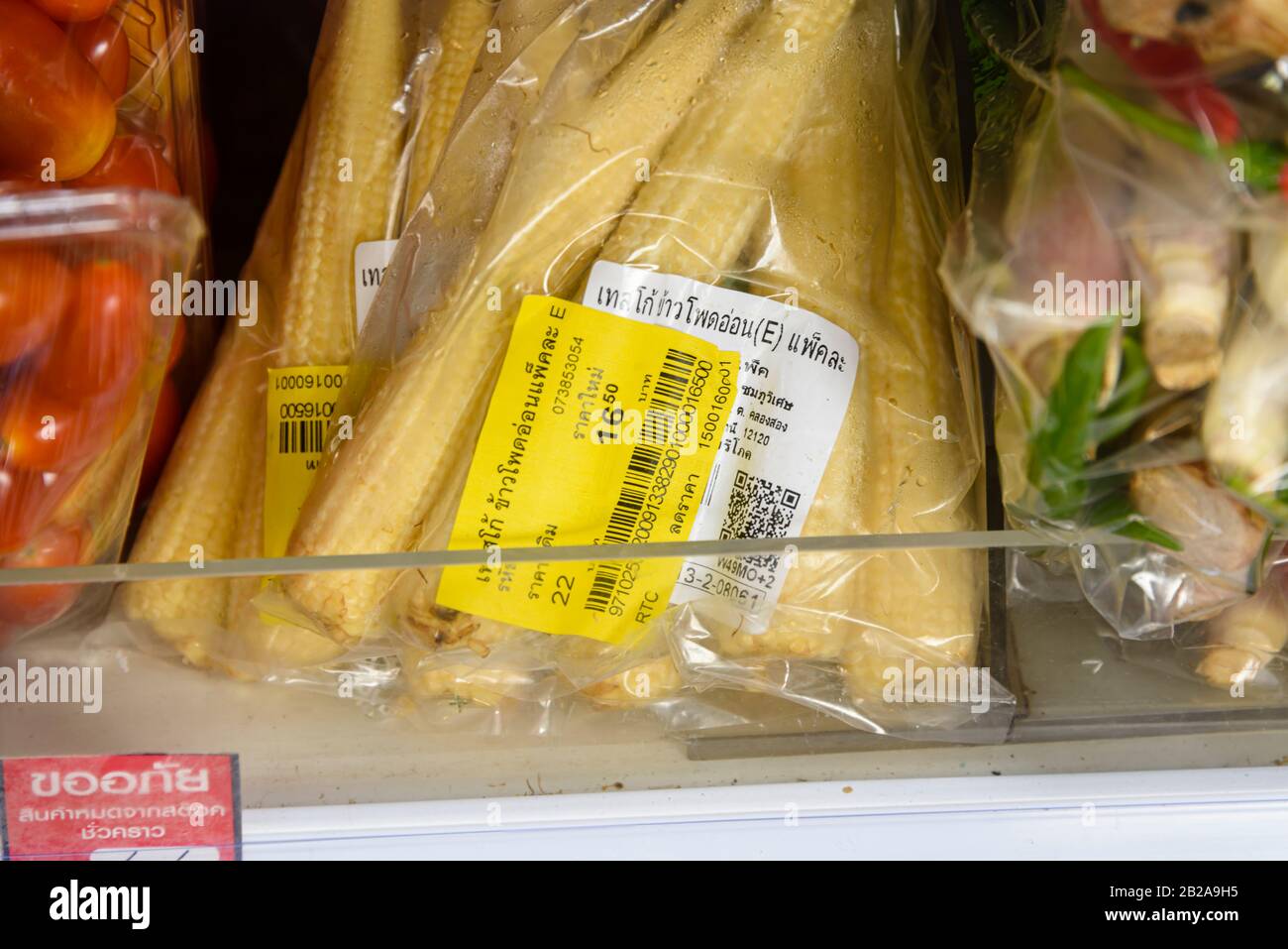 Baby sweetcorn with a reduced sticker in a Tesco Lotus Express supermarket, Thailand Stock Photo