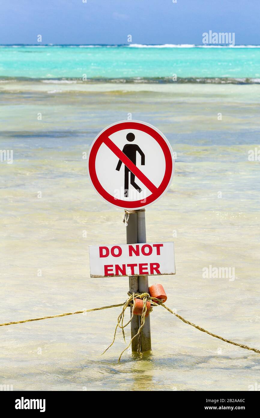 Warning sign by the sea with text do not enter Stock Photo