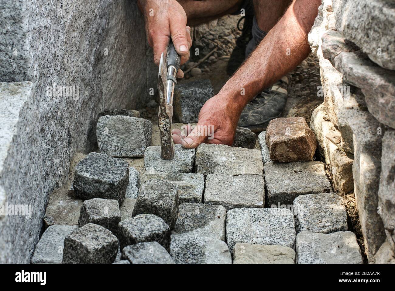 Pavers lay granite stones Stock Photo Alamy