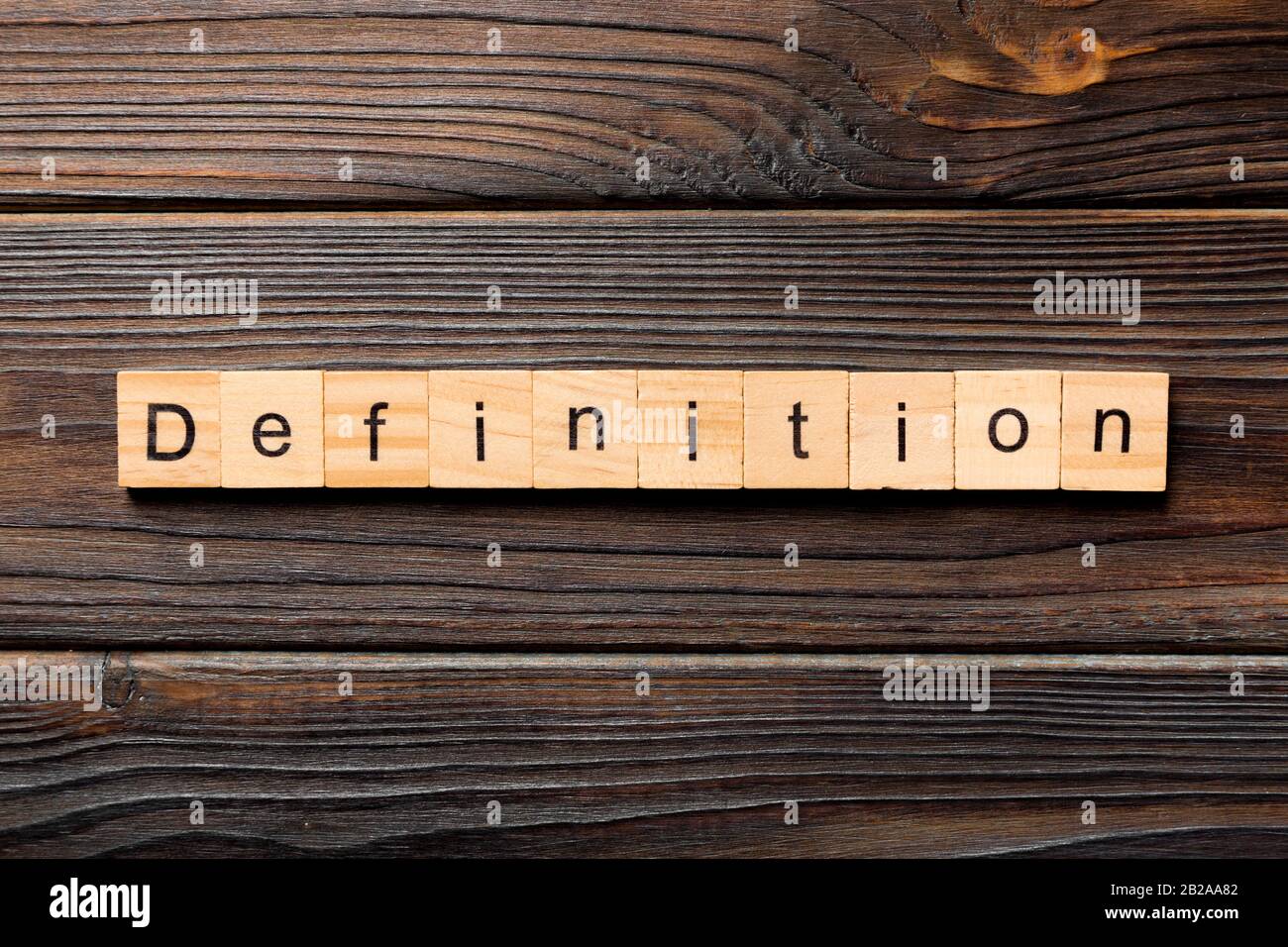 Definition word written on wood block. Definition text on wooden table