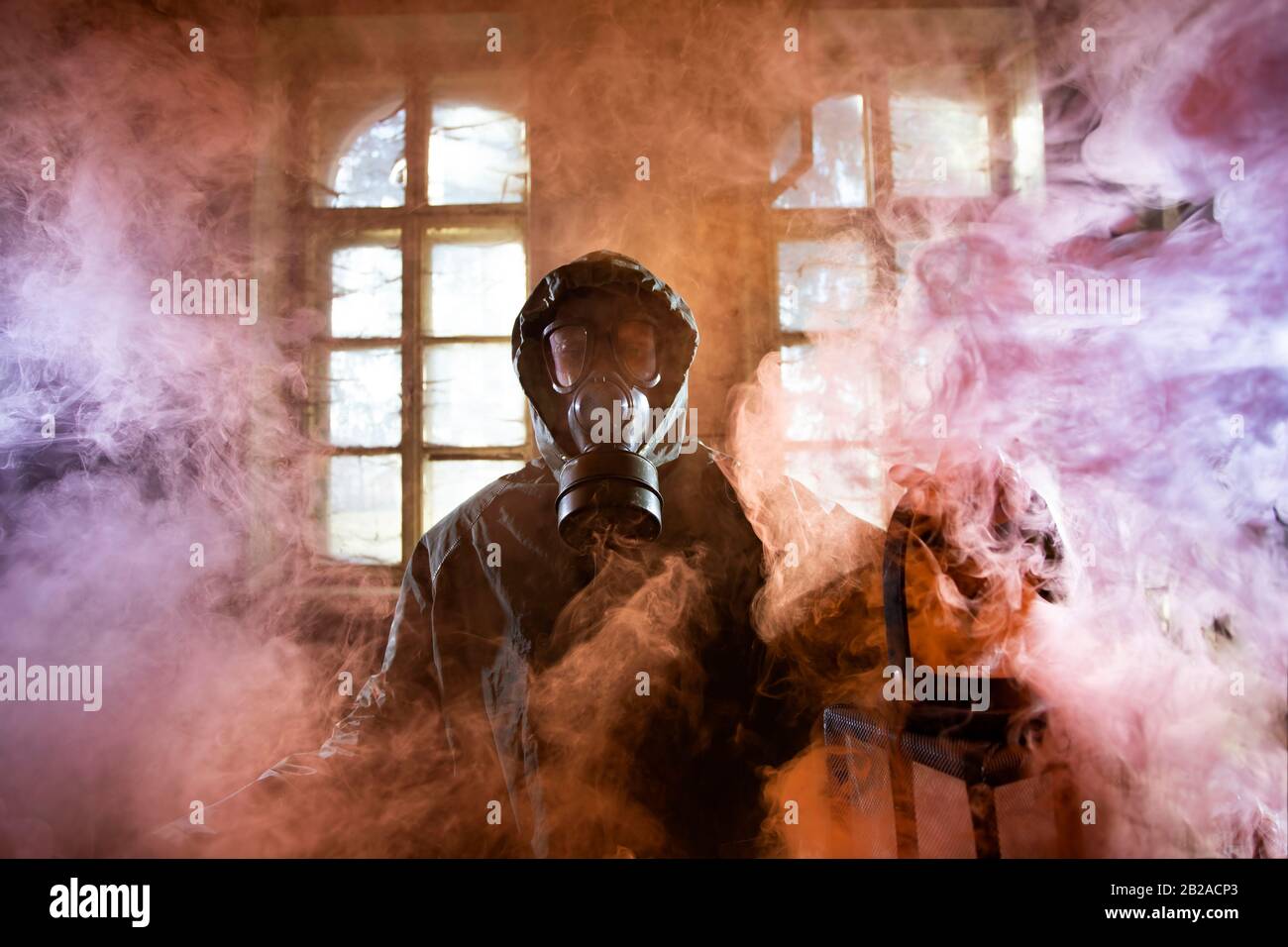Post apocalyptic survivor in gas mask in the smoke. Environmental disaster, armageddon concept. Stock Photo