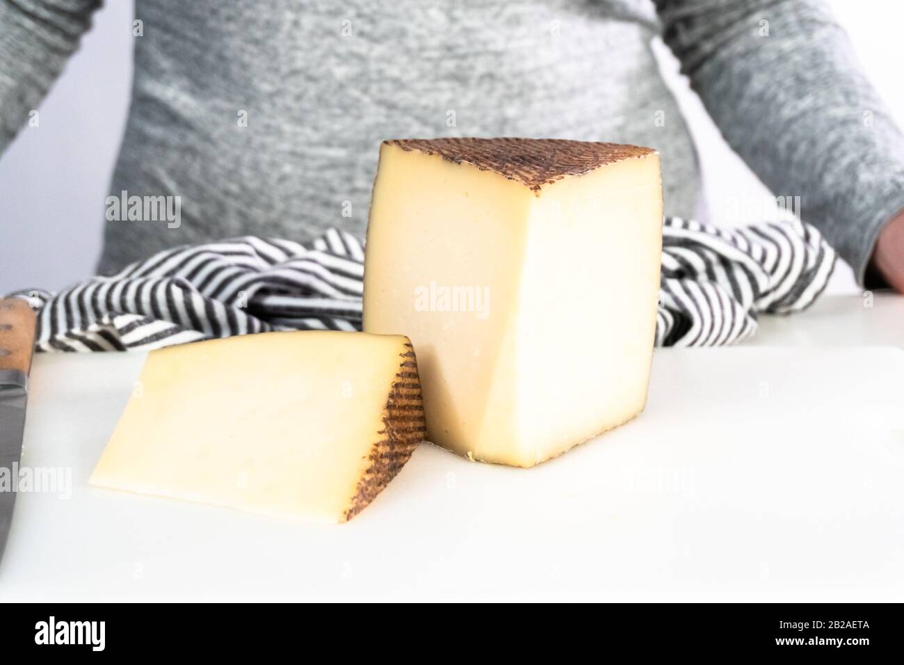 Large slice of aged Manchego cheese on a white background Stock Photo ...