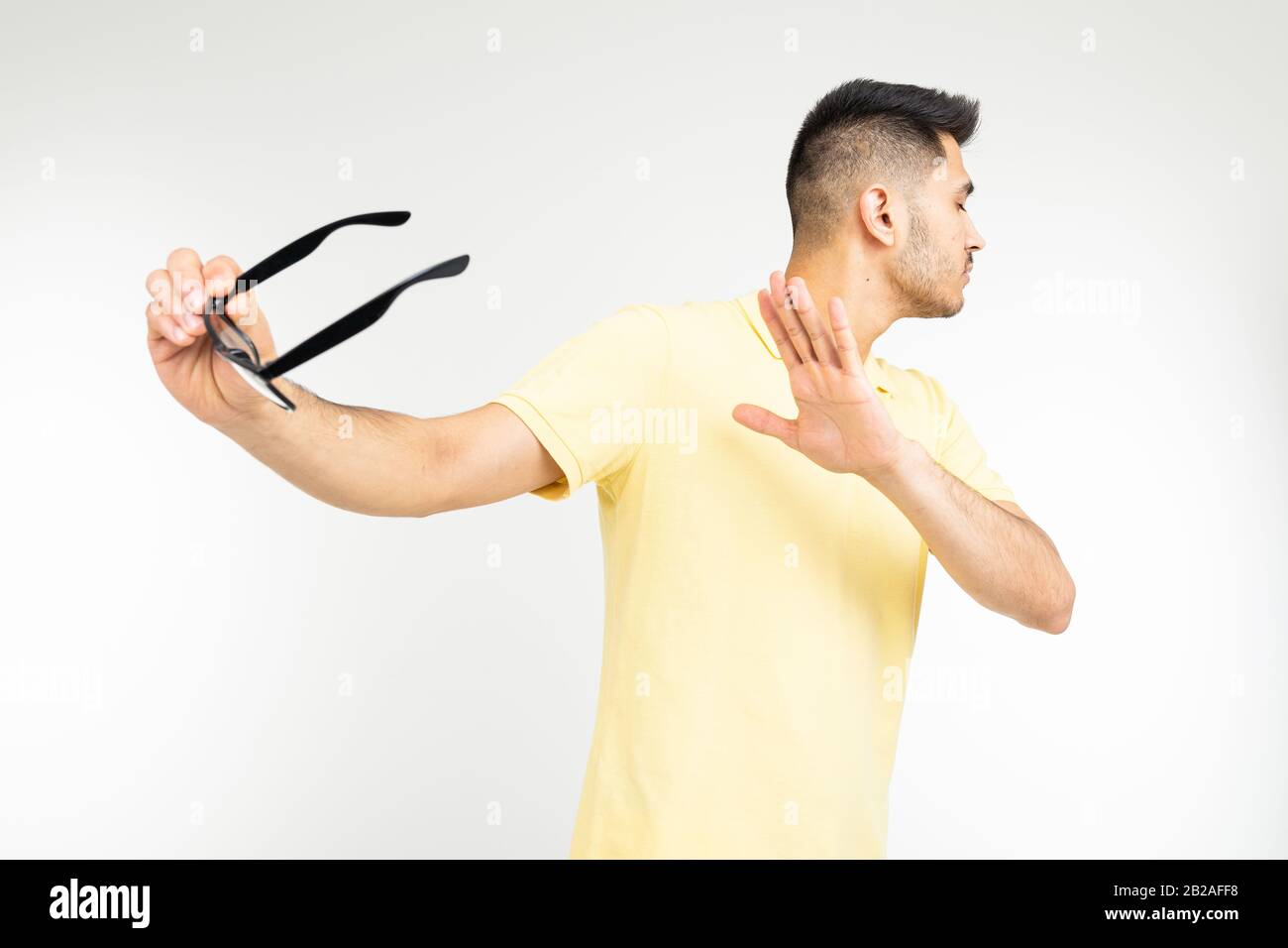 man-refuses-to-wear-glasses-demonstratively-on-a-white-background-2B2AFF8.jpg