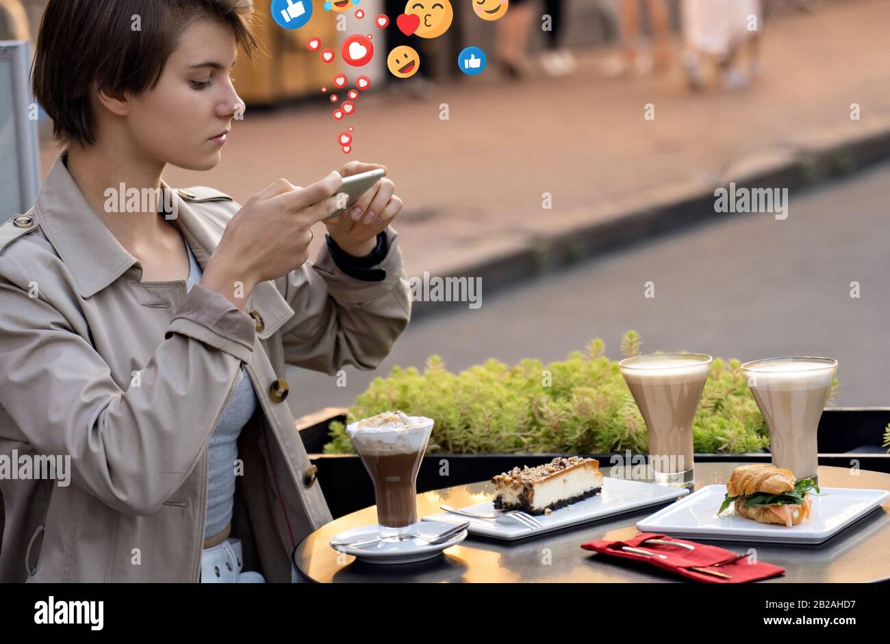 Girl blogger sit at cafe table take food photo for instagram get likes. Stock Photo