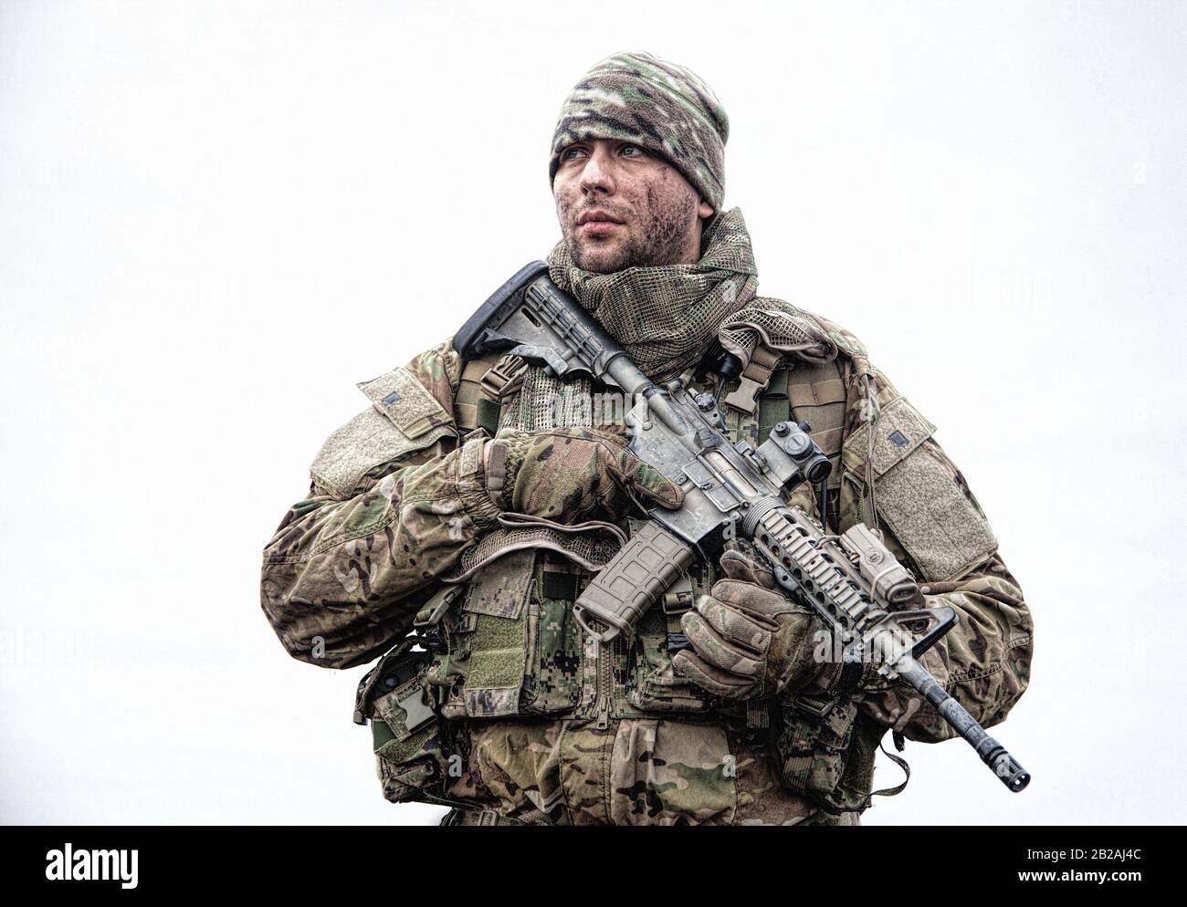 Portrait of soldier, modern combatant with dirty face, firearm replica ...
