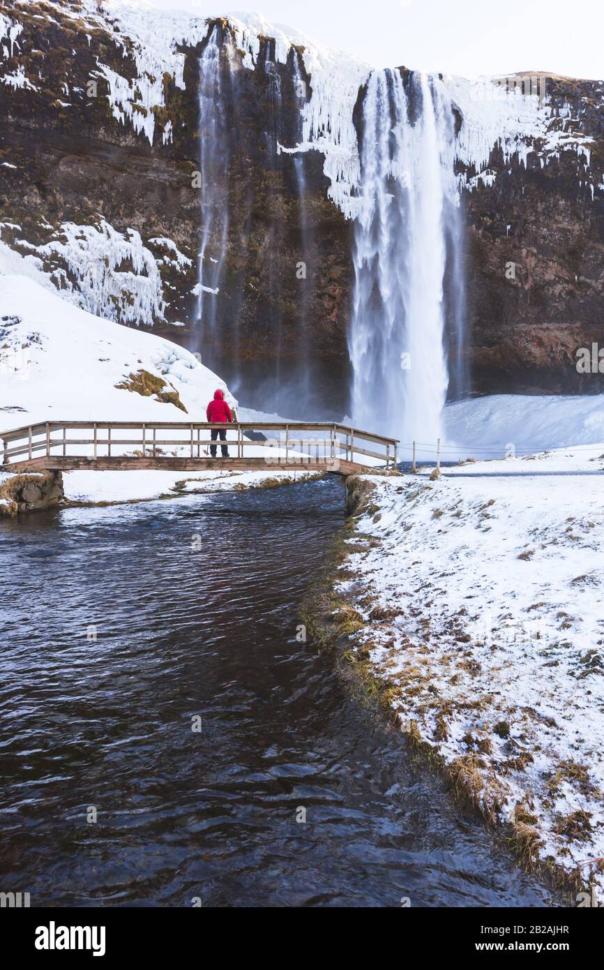 Selyalandfoss waterfall in Iceland. Tourist enjoys the view of the river cascade Stock Photo