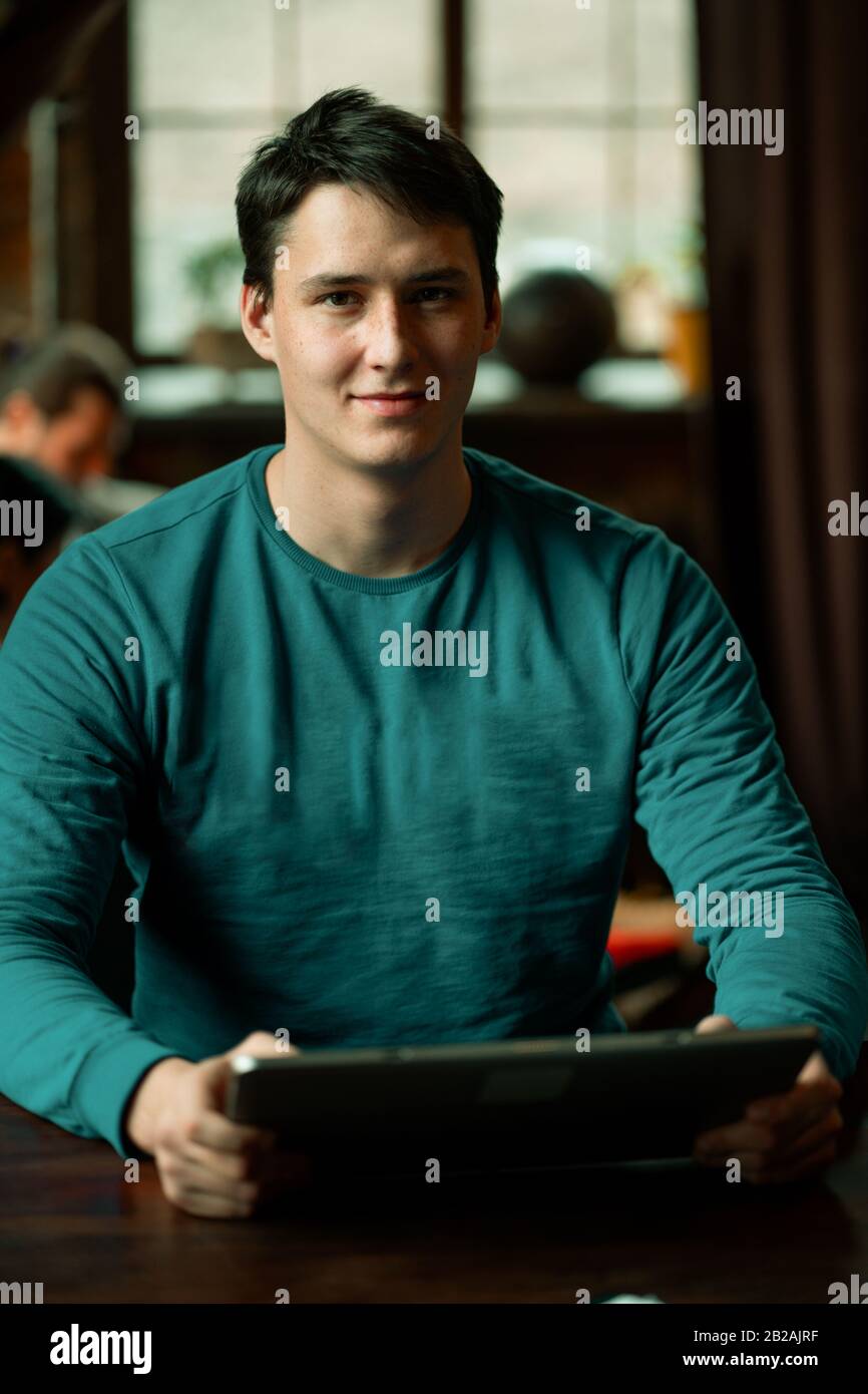 Smiling Caucasian Guy Working In Coworking Space. Stock Photo