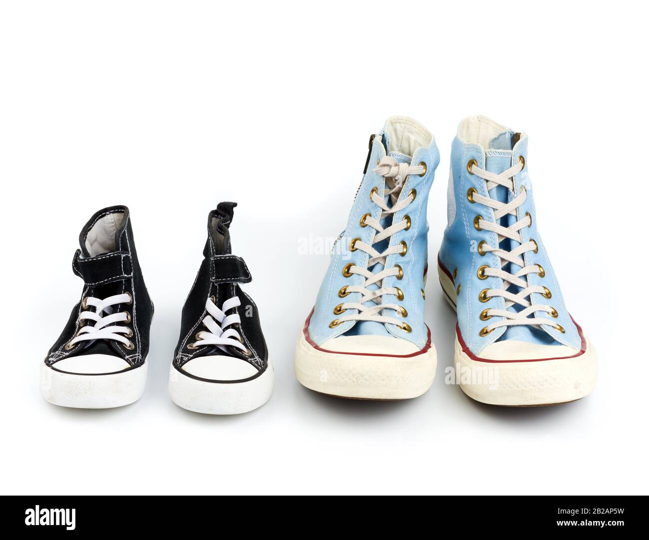 two pairs of textile sneakers with white laces on a white background, shoes  of a child and an adult Stock Photo - Alamy