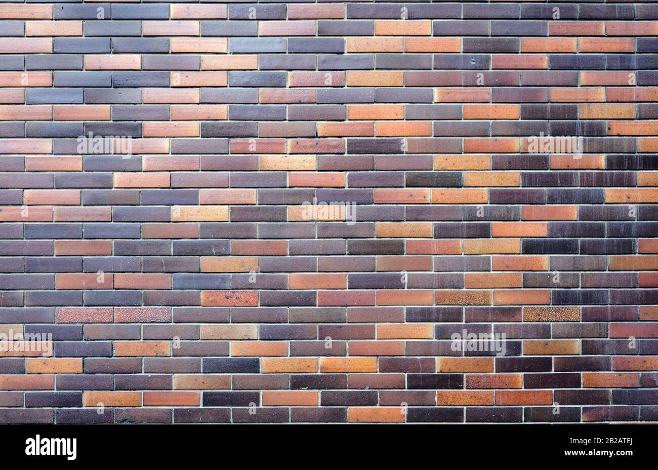 Photo of an old brick wall with different color bricks Stock Photo - Alamy