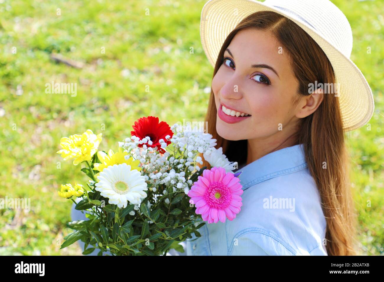 Happy beautiful girl receives a bouquet of flowers in spring time, view from above Stock Photo