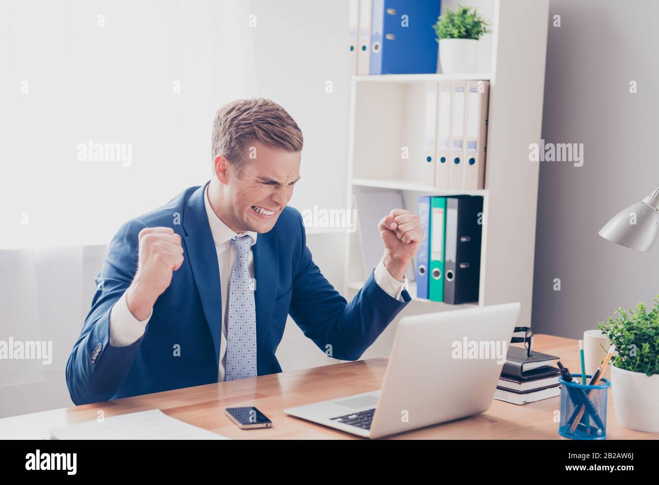 Portrait of angry businessman in bad mood showing fists Stock Photo