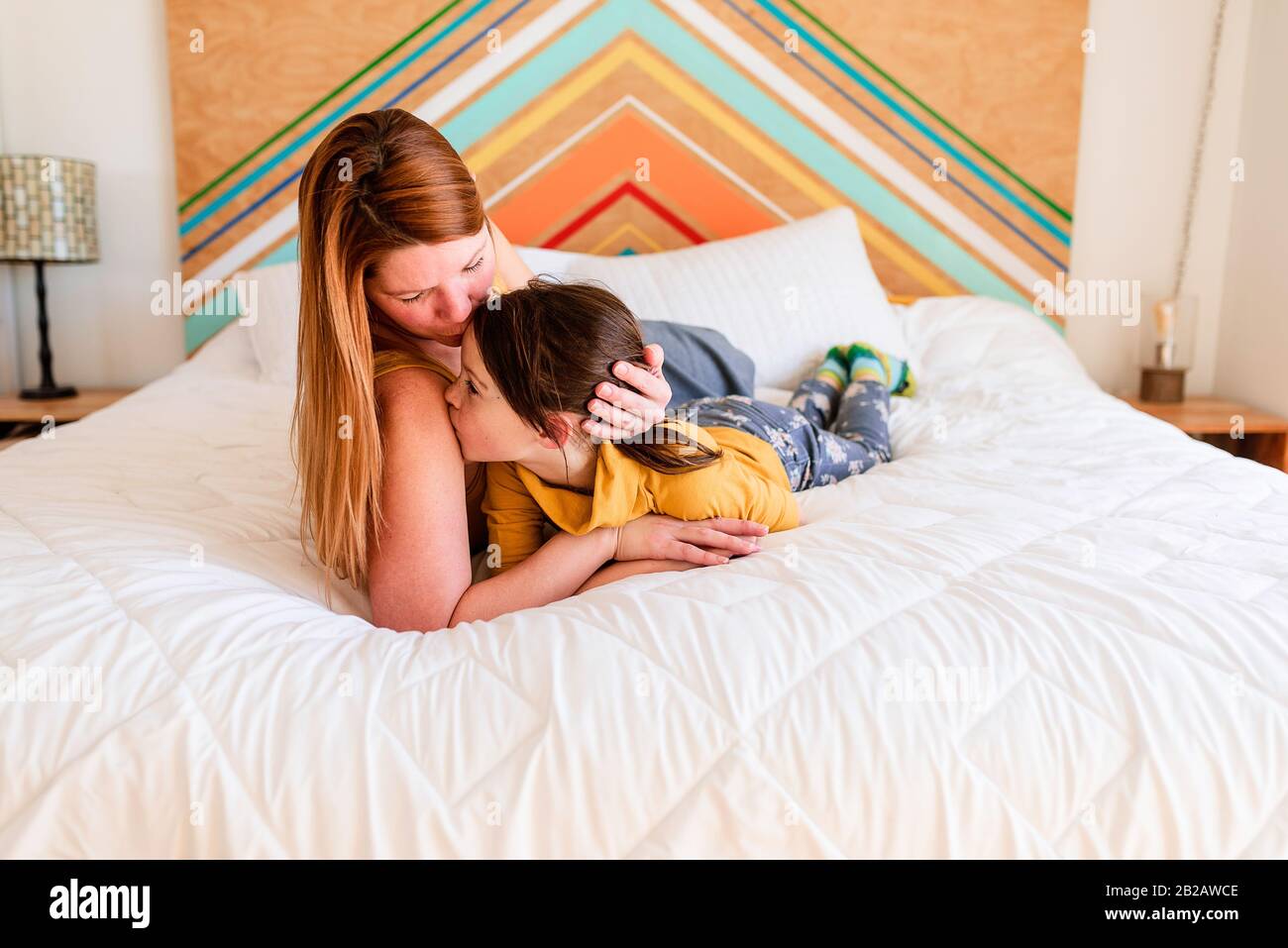 Portrait of a mother and daughter lying on a bed Stock Photo