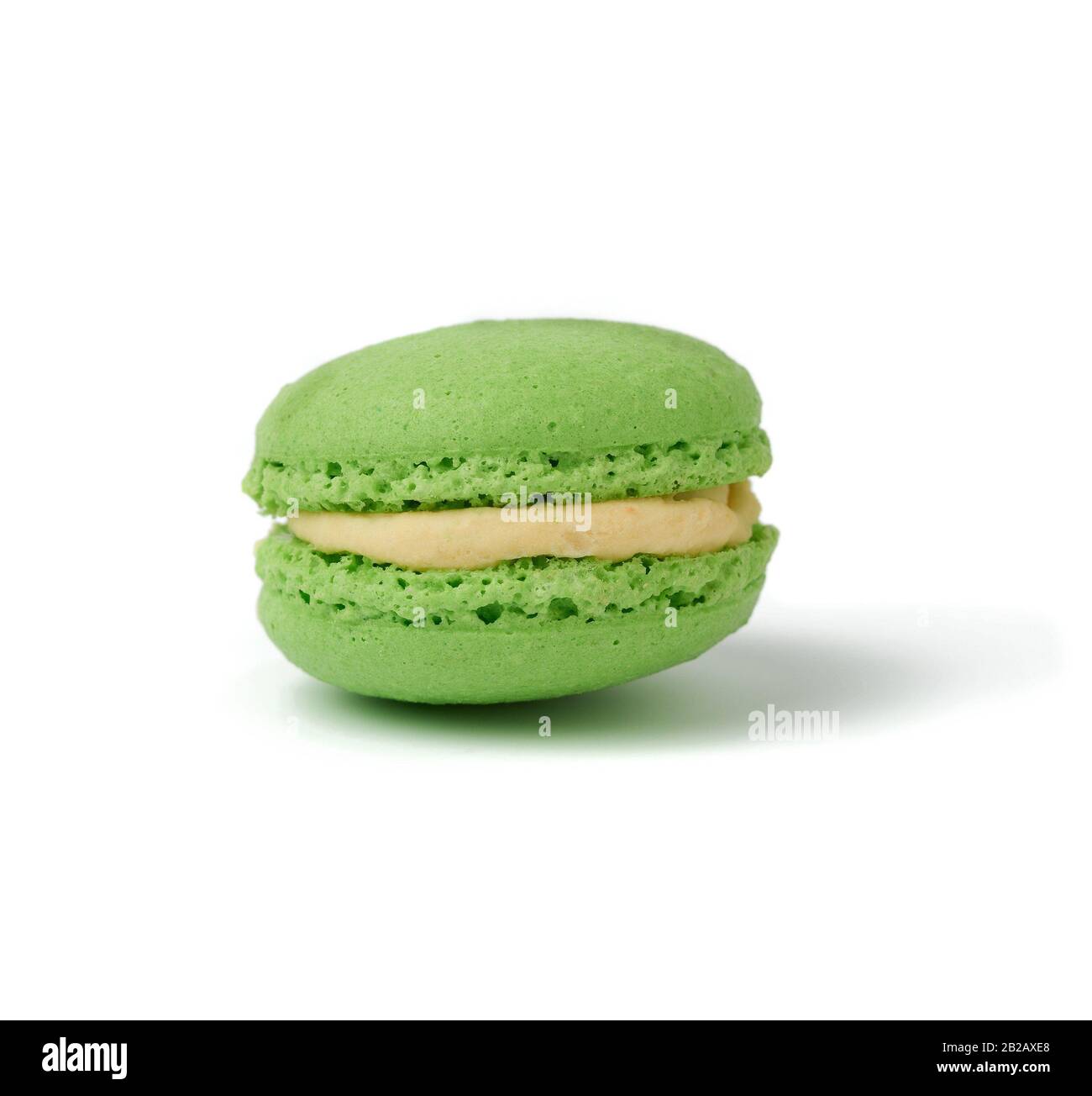 green round baked almond flour macaron isolated on a white background, delicious popular french
