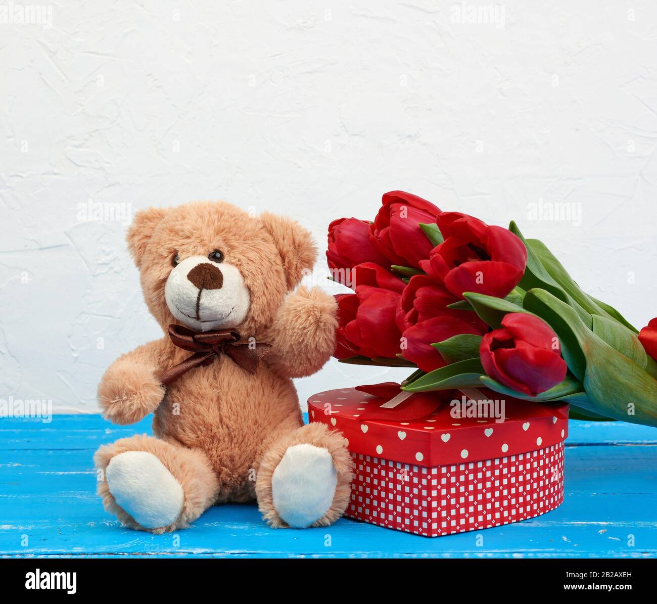 Cute Brown Teddy Bear Sits On A Blue Wooden Background Bouquet Of Red Tulips Red Box Festive Backdrop For Birthday Valentine S Day Anniversary Stock Photo Alamy