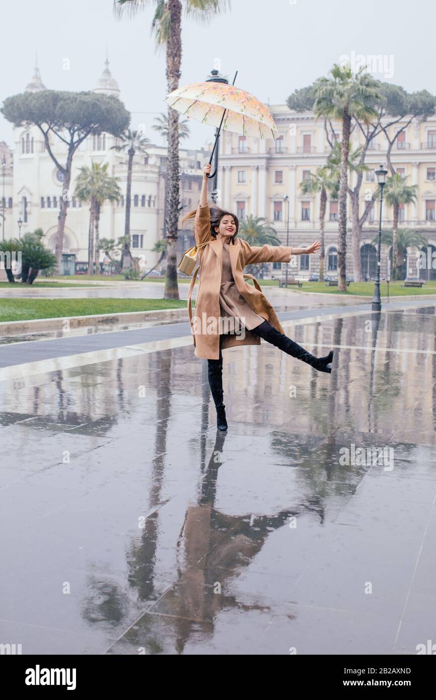 Woman dancing in the rain, Rome, Lazio, Italy Stock Photo