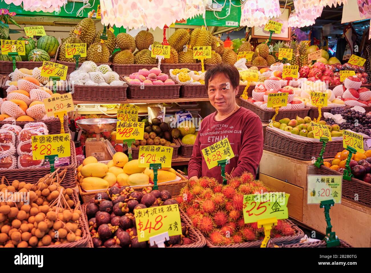 Fruit seller at his stall operating at Fa Yuan Street Market in Mong