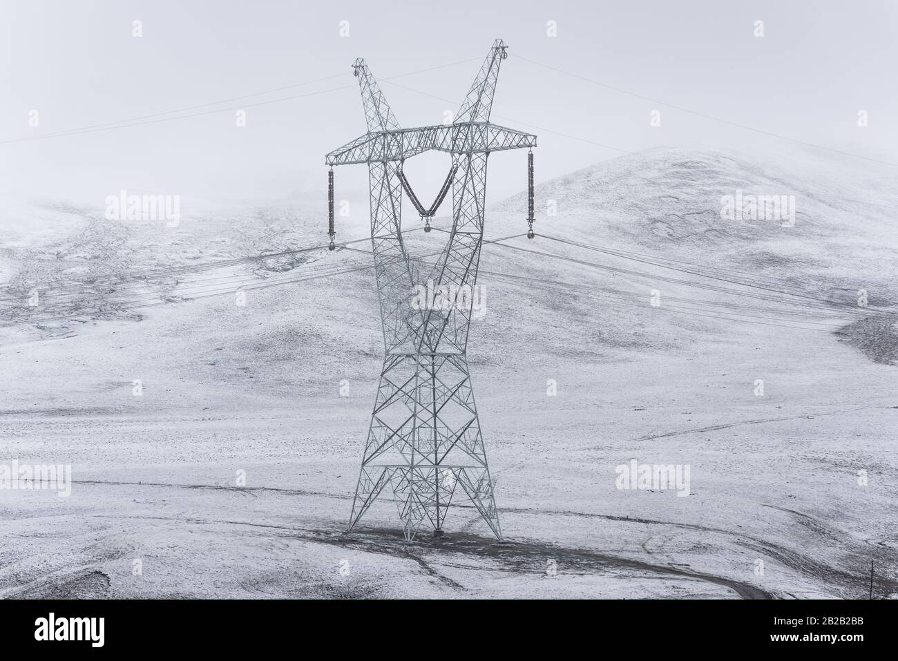 electricity pylon on a mountain which covered with snow Stock Photo - Alamy