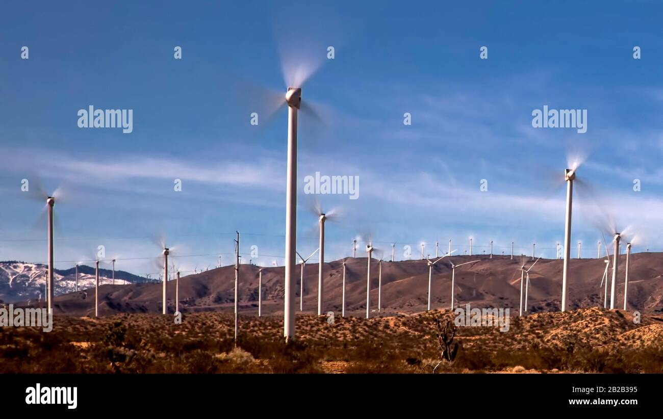 Wind Turbines spin in the Tehachapi Mountains of Southern California. Stock Photo