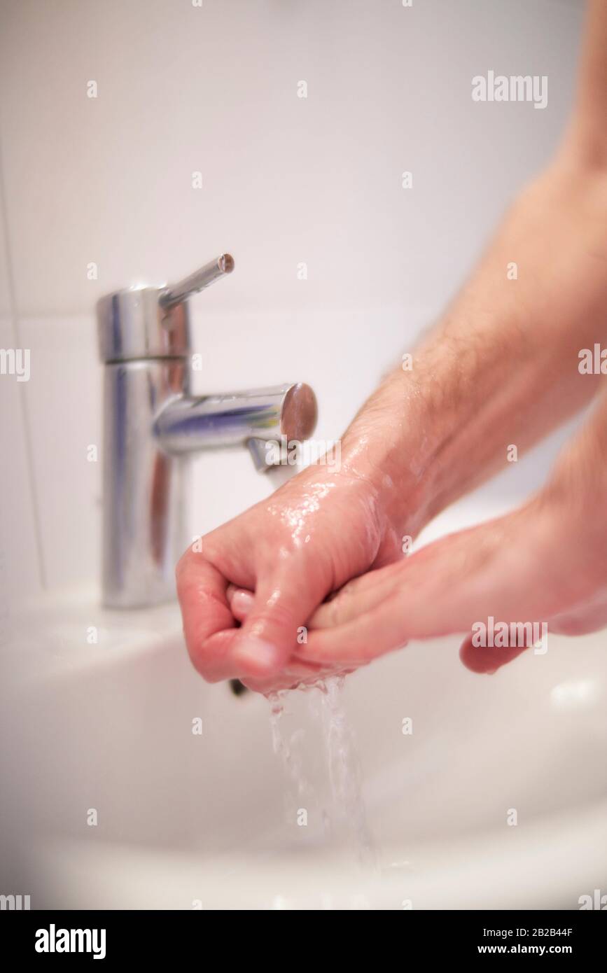 Man washing his hands Stock Photo Alamy