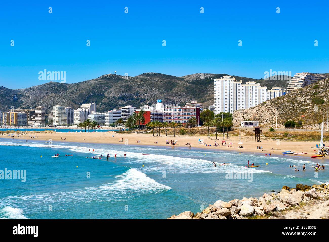 CULLERA, SPAIN - JUNE 23: Sunbathers at Raco Beach on June 23, 2016 in Cullera, Spain, with the the San Antonio Beach, the main beach in this popular Stock Photo
