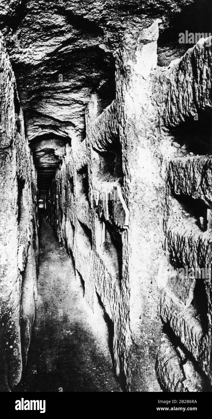 The photo shows the underground cemeteries of Rome as they used to be until the 4th century. The photo shows a corridor in the oldest complex from the 2nd century in the Domitilla cemetery with burial chambers hewn into soft tuff stone in corridors that were 60 to 80 cm wide and 2-8 m high. This form of burial was already known to the Roman Jews and was adopted by the early Christians. The catacombs fell into oblivion in the Middle Ages and were rediscovered by chance in the 16th century. Stock Photo