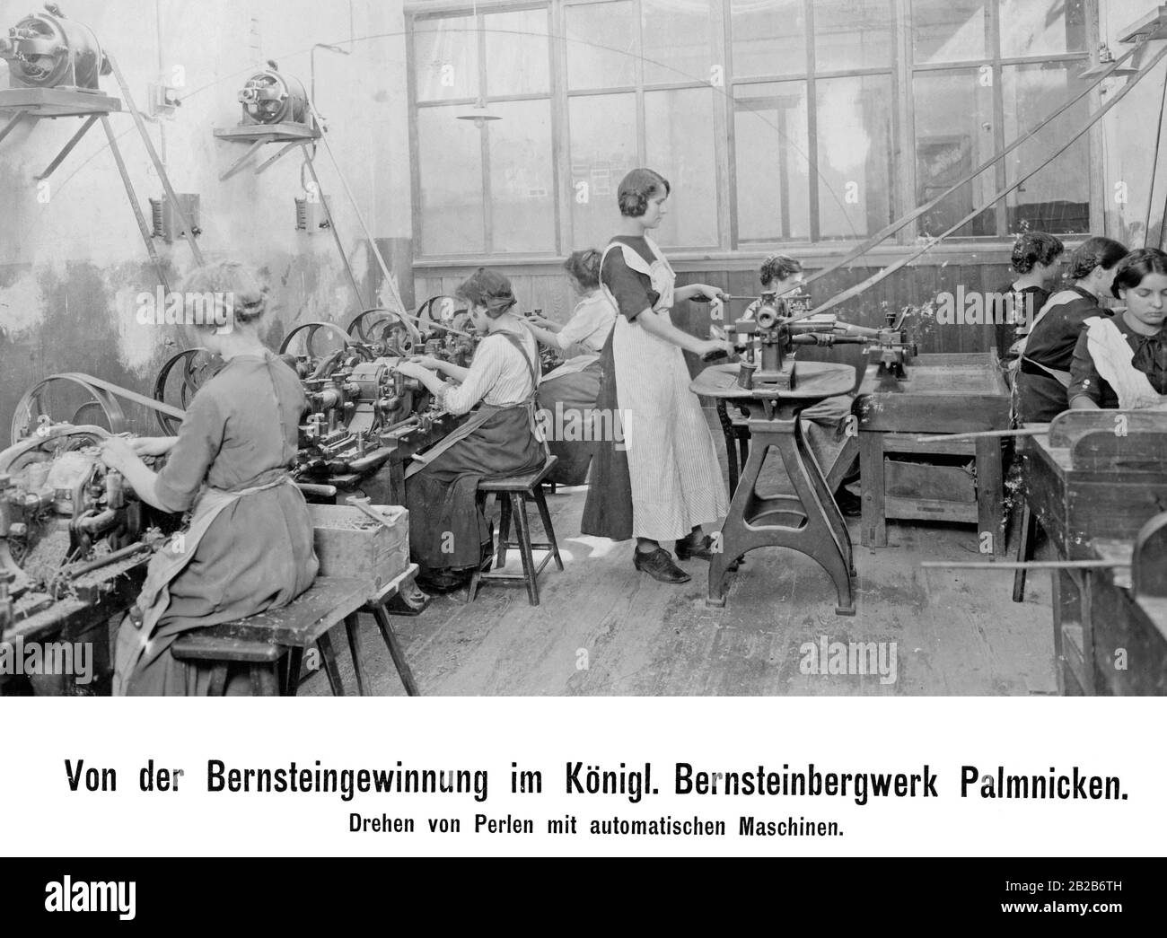 Women shaping beads with automatic machines in the Royal Amber Mine Palmnicken. Stock Photo