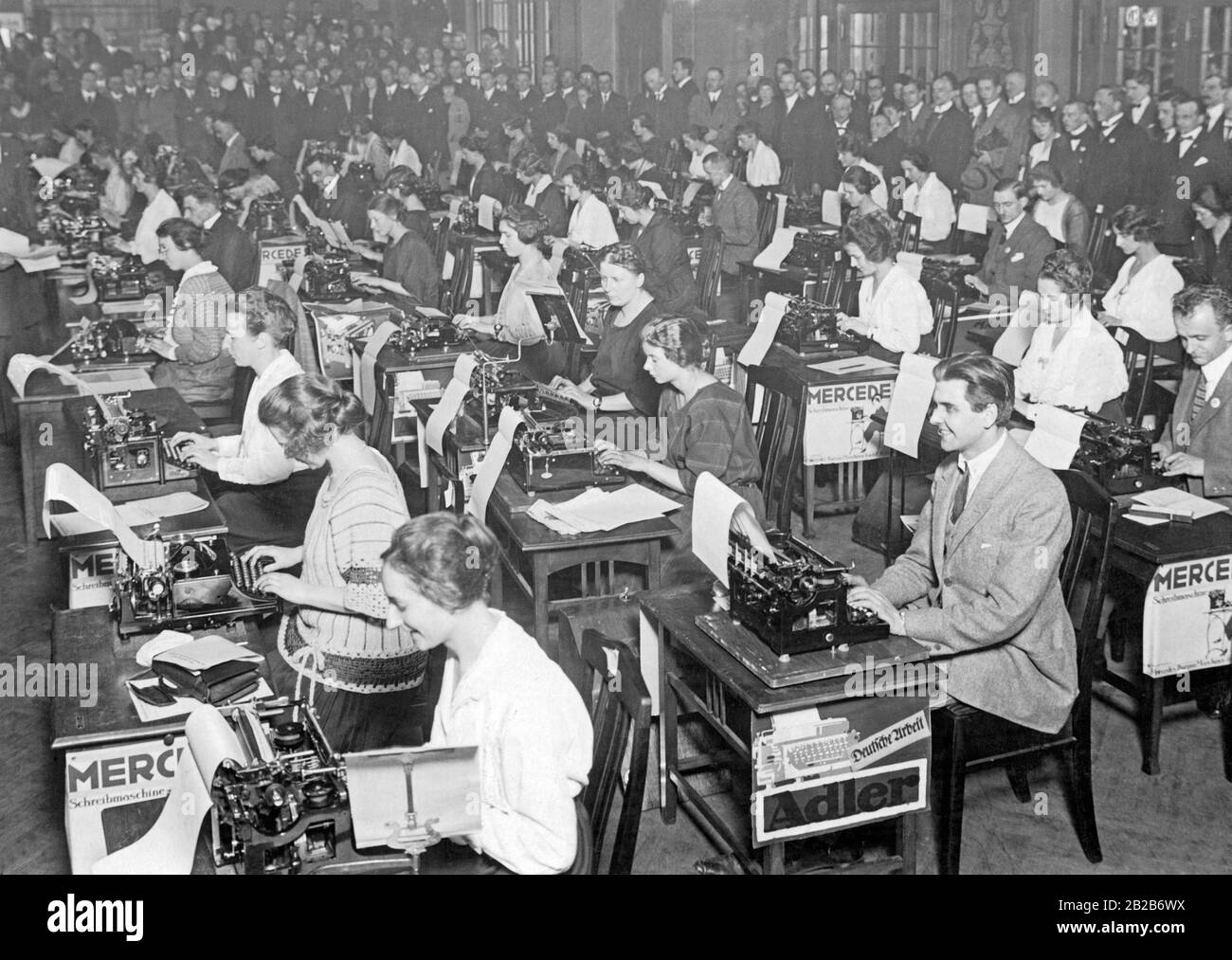 The first typewriter competition in Berlin, in which a 200,000 Mark prize of the 'Berliner Lokal-Anzeiger' could be won. It was the last months of inflation, when the Reichsmark lost value every day. Participants used Mercedes and Adler typewriters. Stock Photo