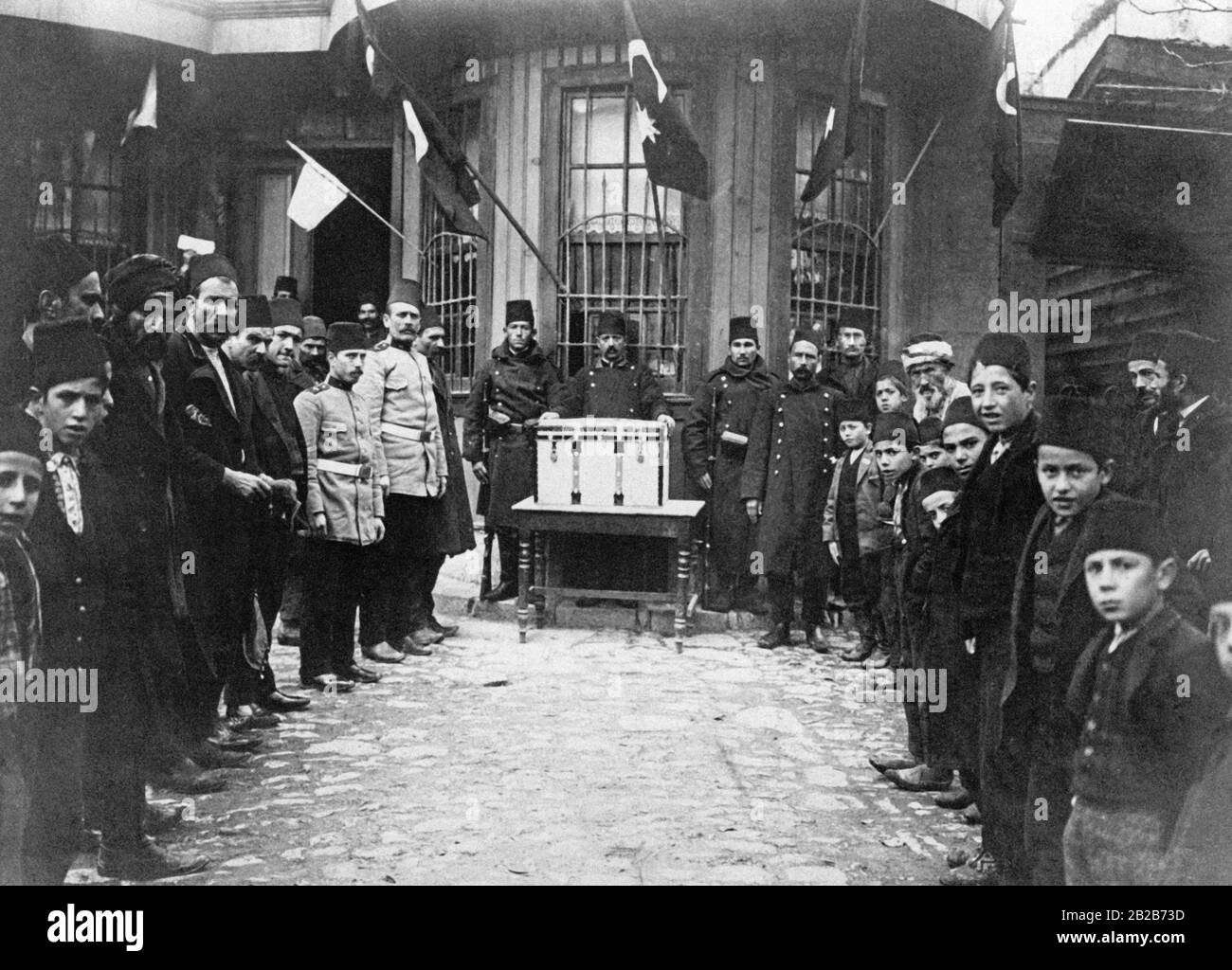 A ballot box locked in a suitcase is placed in front of a mosque by young Turkish activists in Constantinople. The elections will be held on 10 December 1908. Stock Photo