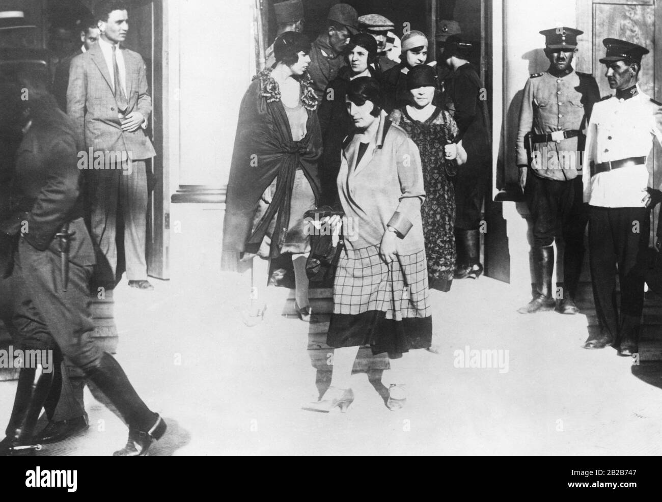 A group of persons present at the trial, including many unveiled women, leave the trial of the Turkish conspirators in Izmir, who will be executed afterwards. They were accused of a failed assassination attempt on Atatuerk. Stock Photo