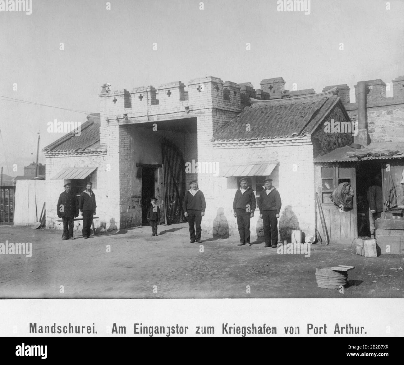 Men and a boy in front of the entrance gate to Port Arthur, today's Lüshunkou. Stock Photo