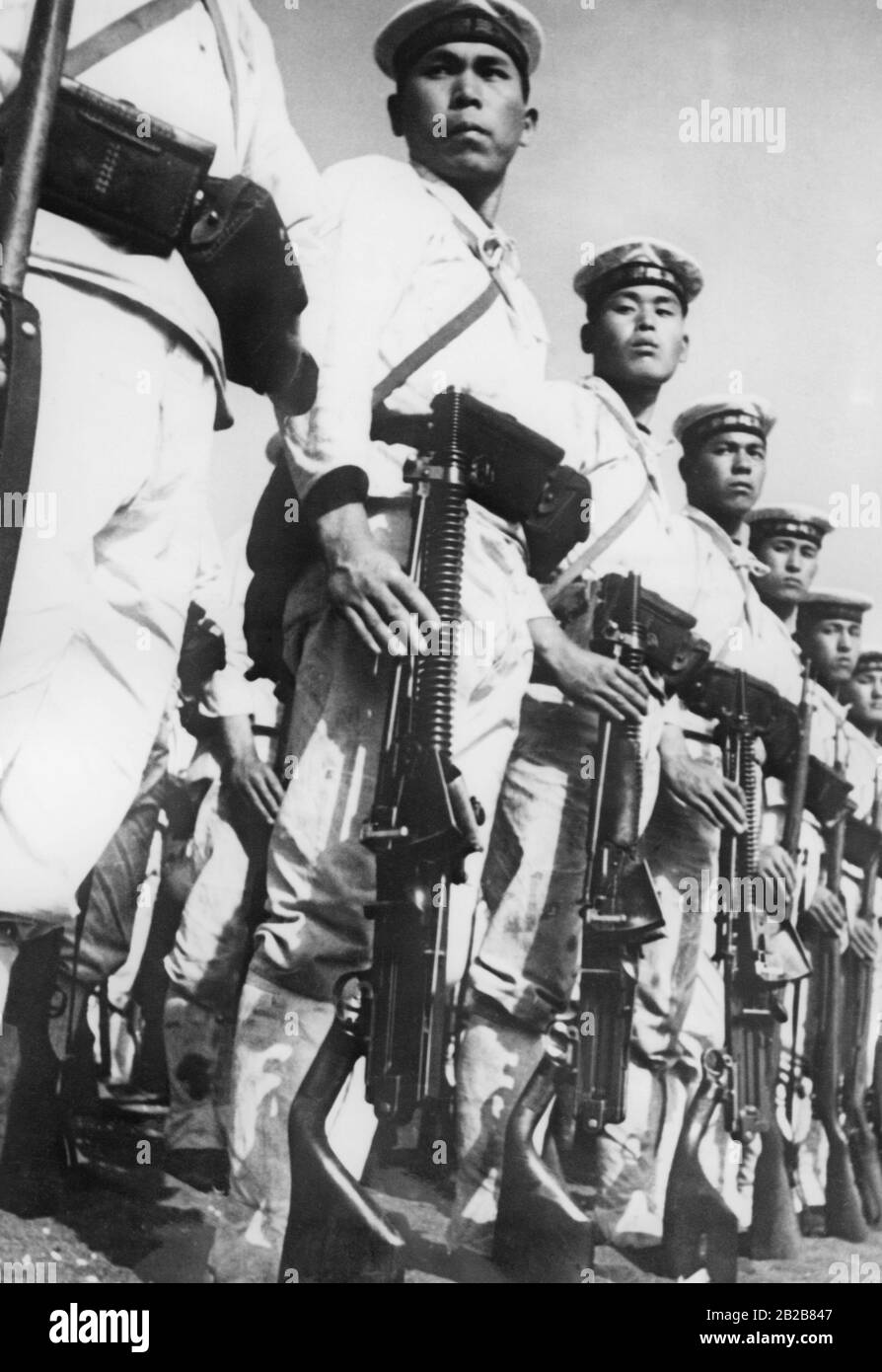 Japanese marines armed with rifles and machine guns are lined up for a parade. Stock Photo