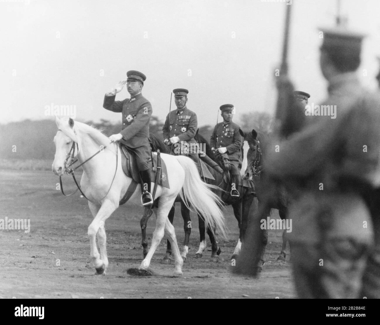 The Japanese Emperor Hirohito takes the salute of troops during a parade on April 29, 1939. Stock Photo