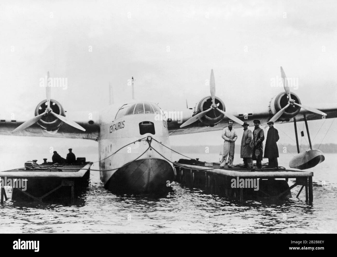 Passengers board the flying boat 'Centaurus' of Imperial Airways via a floating gate. Stock Photo