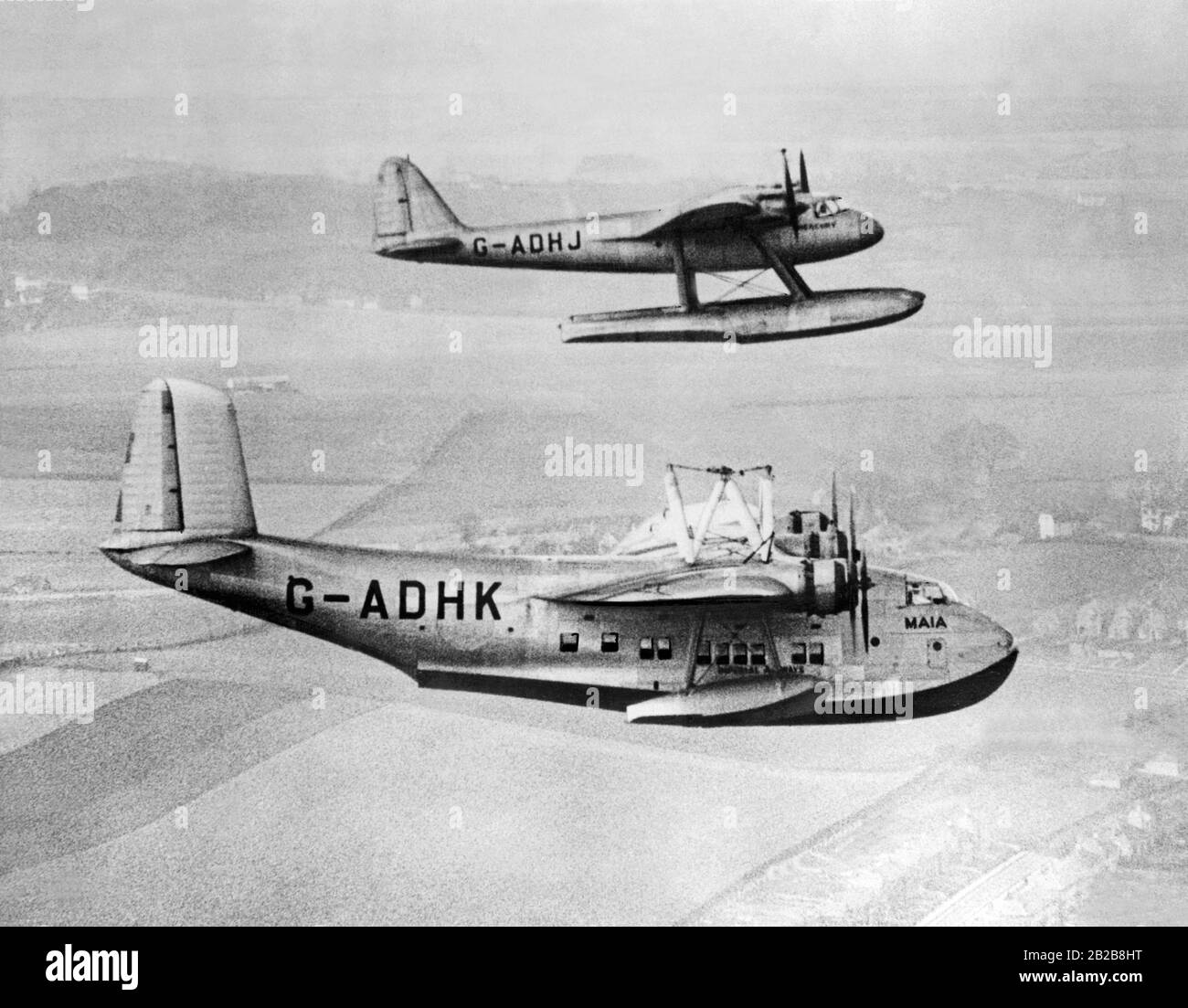 The Short Mayo Composite aircraft consists of a Short Empire flying boat (G-ADHK 'Maia') which carries a smaller Short Mercury seaplane (G-ADHJ). The 'Mercury' was carried by the 'Maia' up to cruising altitude, then the planes parted company and the 'Maia' returned to the airport of departure. Thus the 'Mercury' could cover longer distances. Stock Photo