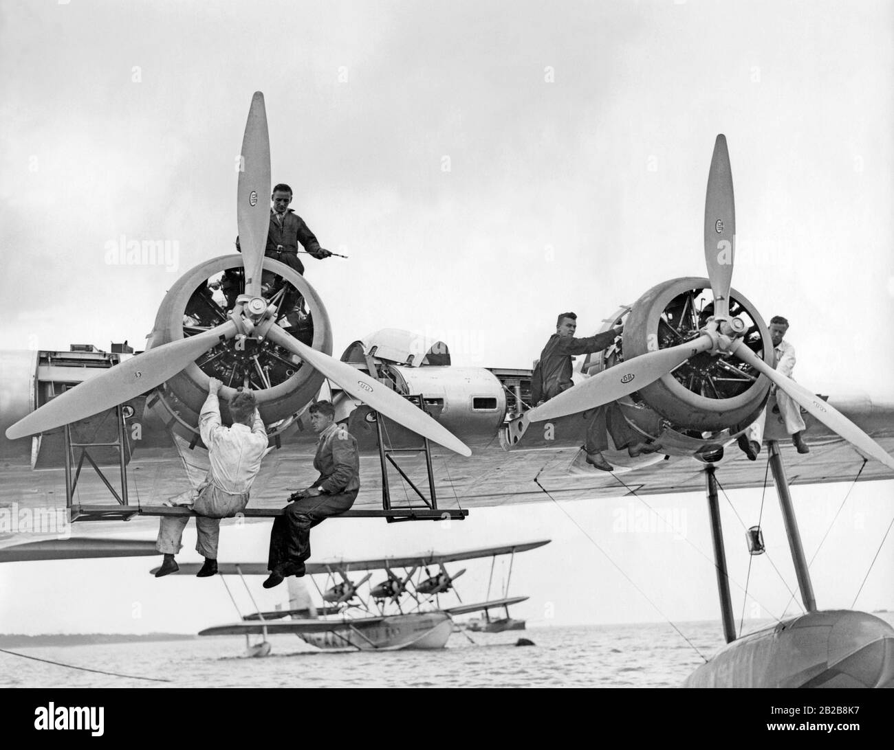 Maintenance work is performed on a Short Empire flying boat before a