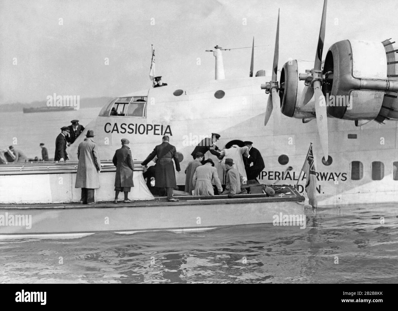 Passengers board the flying boat 'Cassiopeia'. The maiden flight of the 'Cassiopeia' was from Southampton to Alexandria. Stock Photo