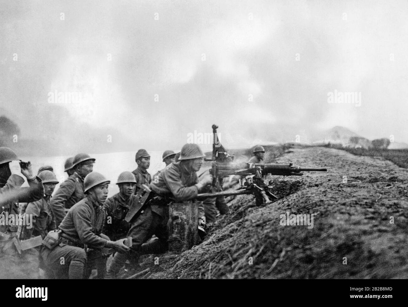A group of Japanese soldiers in a gun emplacement during a battle. Stock Photo