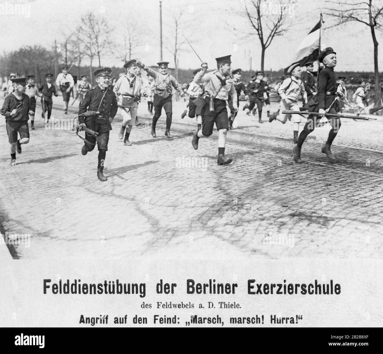 Field exercise of the Berlin drill school of the retired sergeant Thiele. The teenagers practice attacking the enemy. Stock Photo