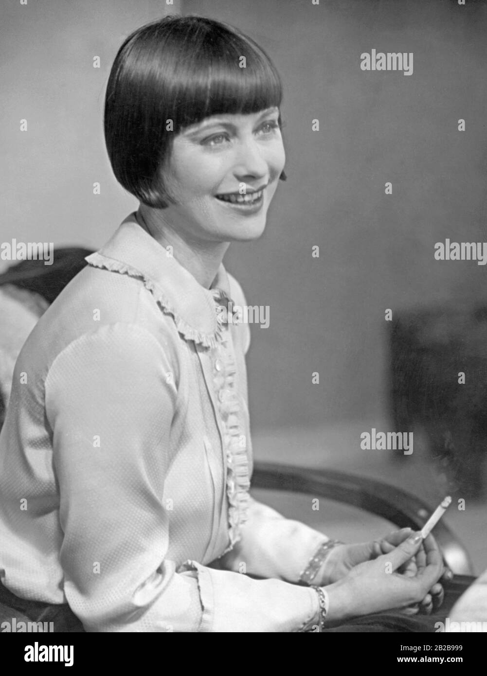 An emancipated woman with bob haircut and cigarette from the 1920s, very different from the type of woman before 1914. Stock Photo