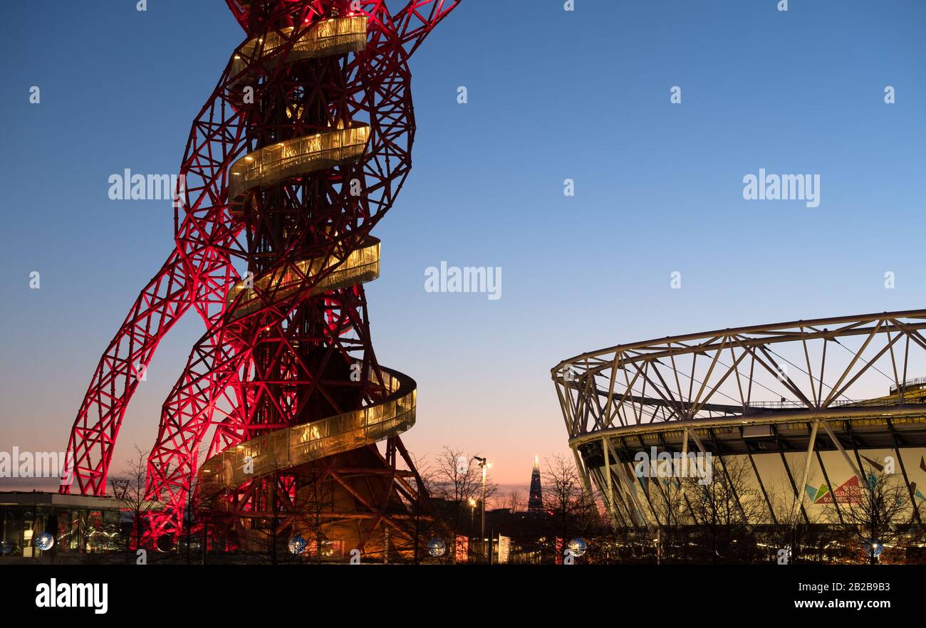 Arcelormittal Orbit and London Stadium illuminated at dusk, Olympic Park London Stratford Stock Photo