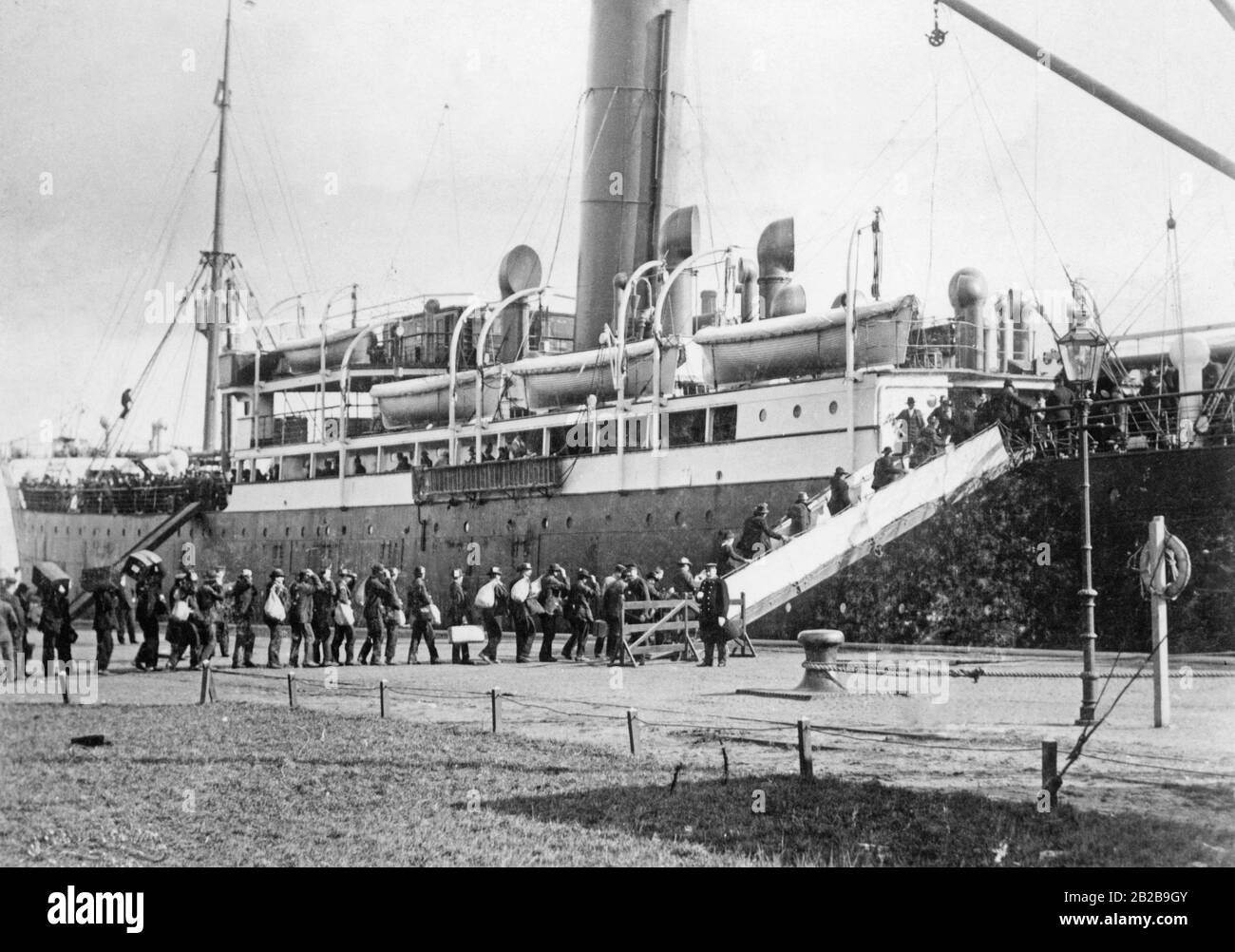 German emigrants board a ship that will take them to America. Stock Photo