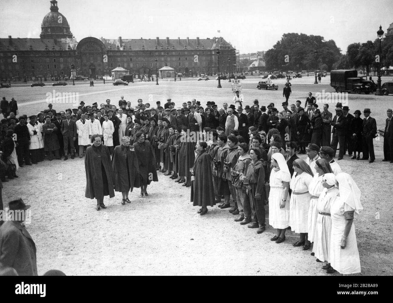 Mobilization in France during the last weeks of peace before the Second World War. In Paris, volunteers are trained as air-raid wardens. On a square in front of the Les Invalides members (three women in the middle, left: Louise Weiss, Julie Cremieux) of the Legion of Honour are inspecting the new volunteer air-raid wardens. Stock Photo