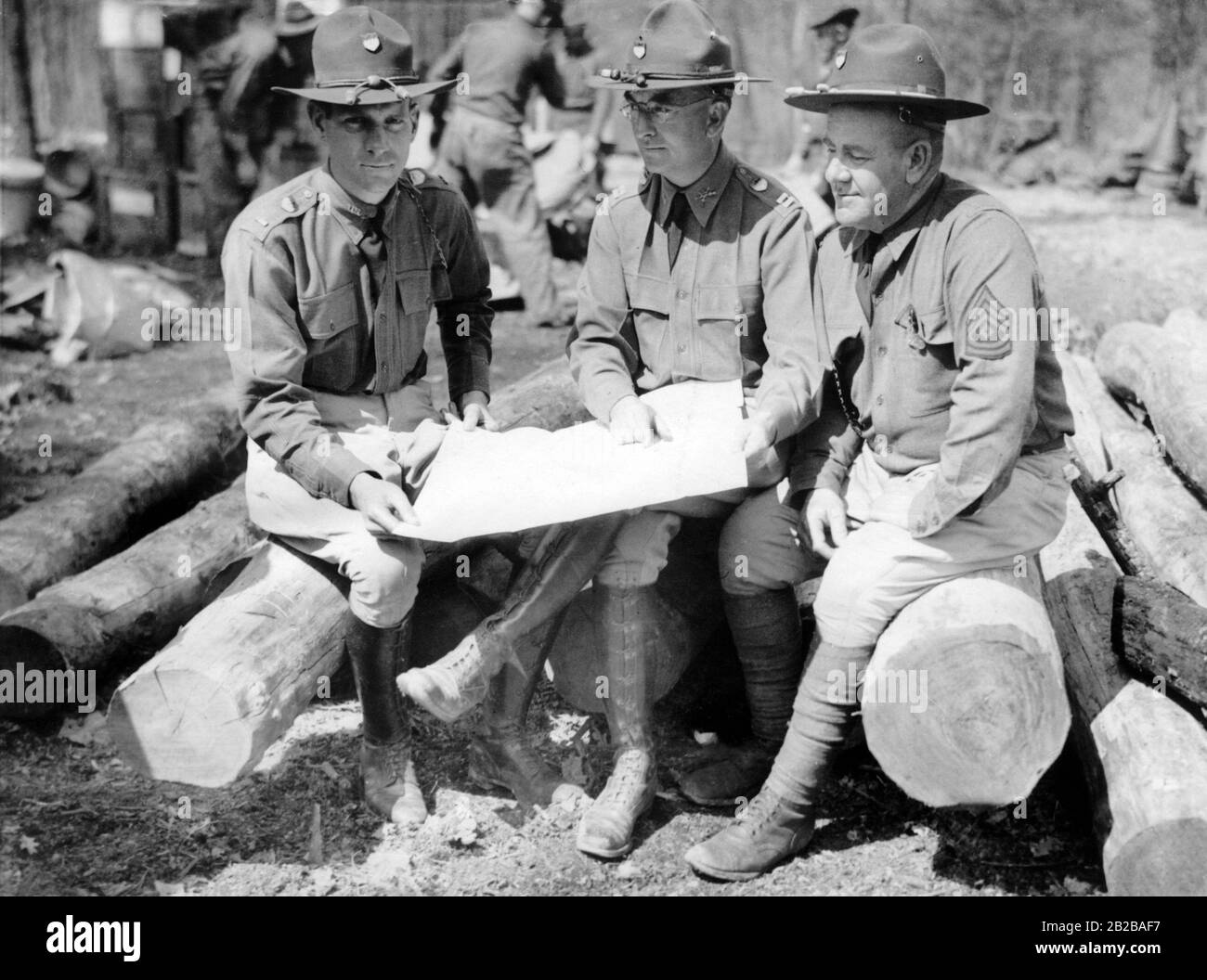 Army officers holding a plan for a Civilian Conservation Corps (A work relief program) camp in Virginia. Stock Photo