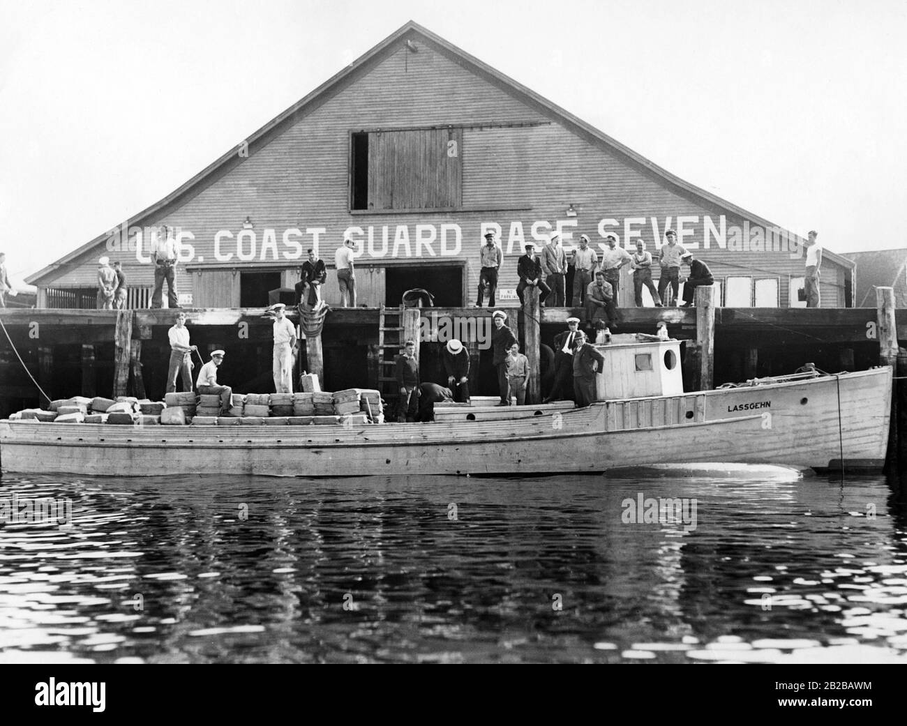 Prohibition: The coast guard ('U.S. Coast Guard Base Seven') and the rum-runner 'Lassgehn' in the harbour of Gloucester in Massachusetts. Stock Photo