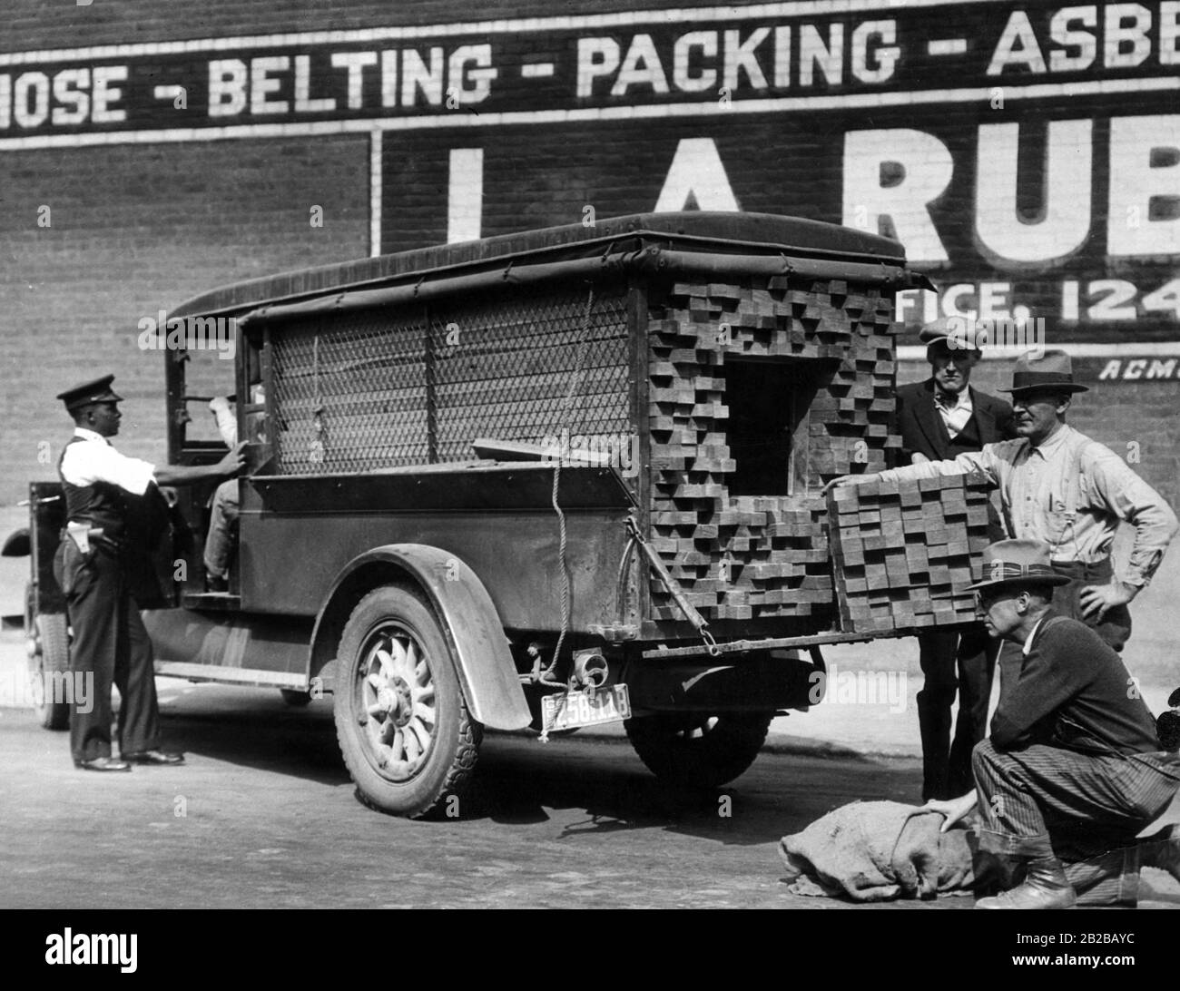 Prohibition: Policemen search a car that was used to smuggle alcohol. Stock Photo
