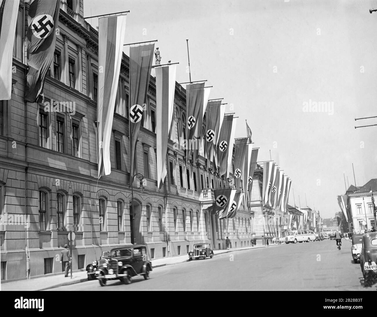 The Wilhelmstrasse decorated with flags in Berlin. On the left, the Reich Ministry of Transport. Stock Photo