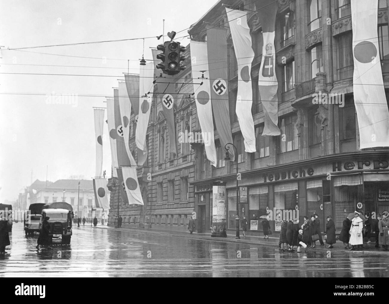 The Wilhelmstrasse decorated with flags in Berlin. Stock Photo