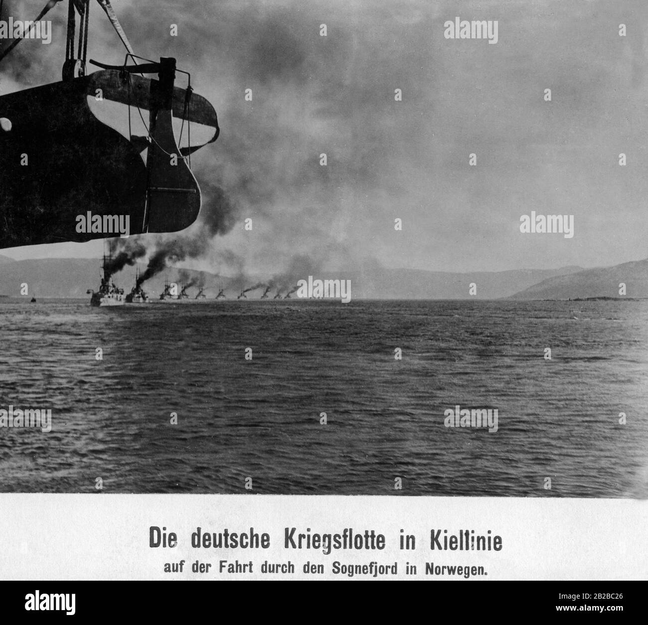 The German war fleet sails one behind the other in the so-called keel line, a certain form of maneuver. They are sailing through the Sognefjord in Norway. Stock Photo